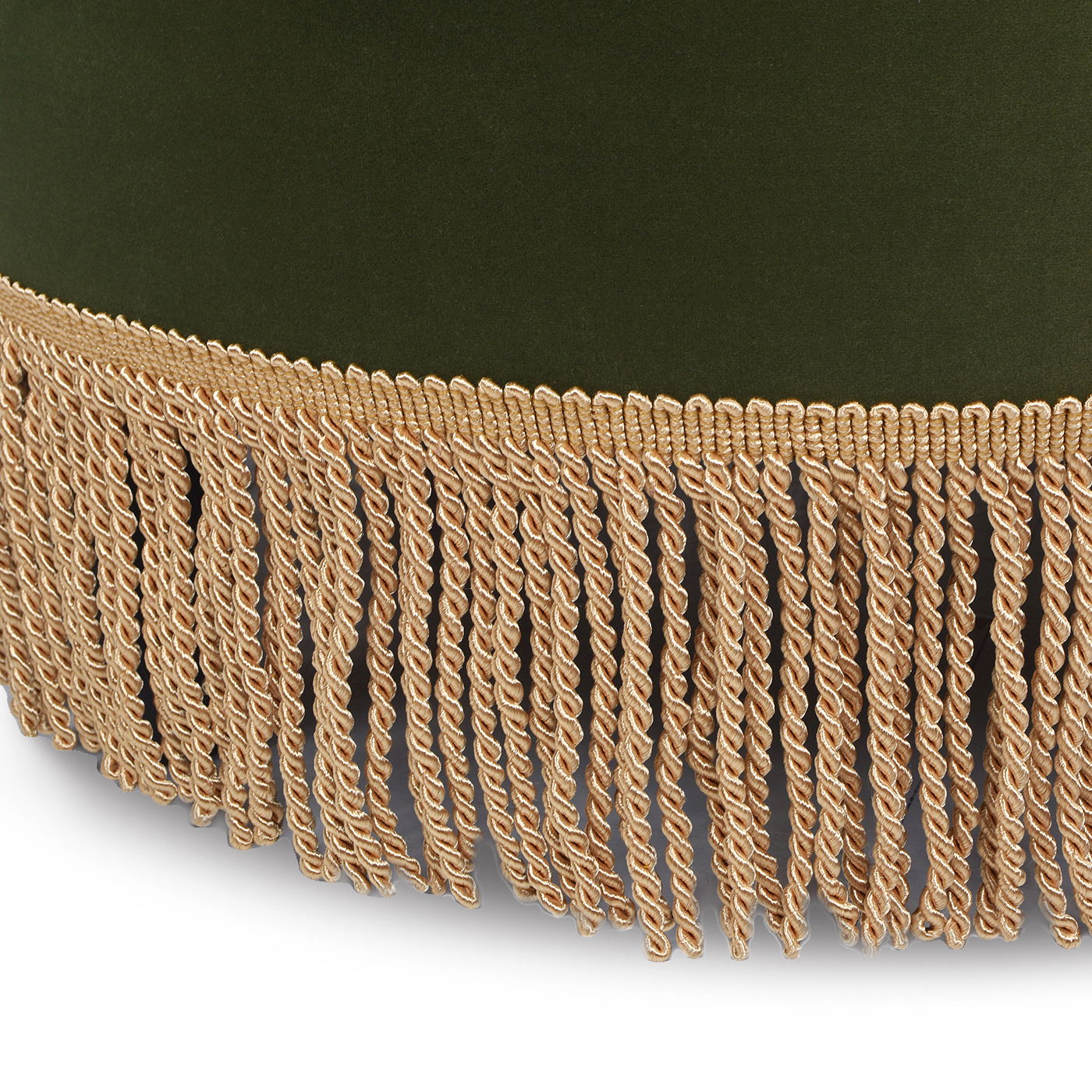 A close-up of the Yolanda Round Upholstered Accent Ottoman, featuring green velvet fabric and a decorative beige fringe trim with loops along the edge.