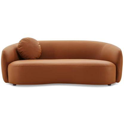 The Porter - Comfortable Sofa features a modern curved design in brown leather with smooth lines and includes a matching round pillow on the left side.