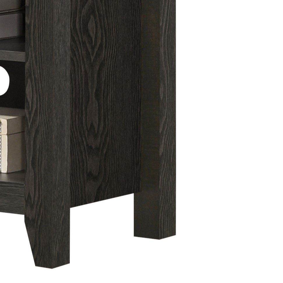 Close-up of the lower side of the Benito TV Stand, featuring dark wood grain, an open shelf with a silver box, and a black circular cable management opening in the back panel.