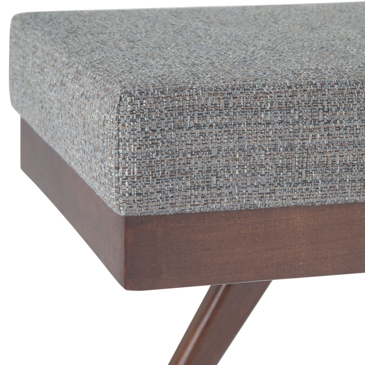 Close-up of the Chanelle Mid-Century Ottoman Bench featuring a cushioned seat in textured gray fabric and a wooden base with angled legs.