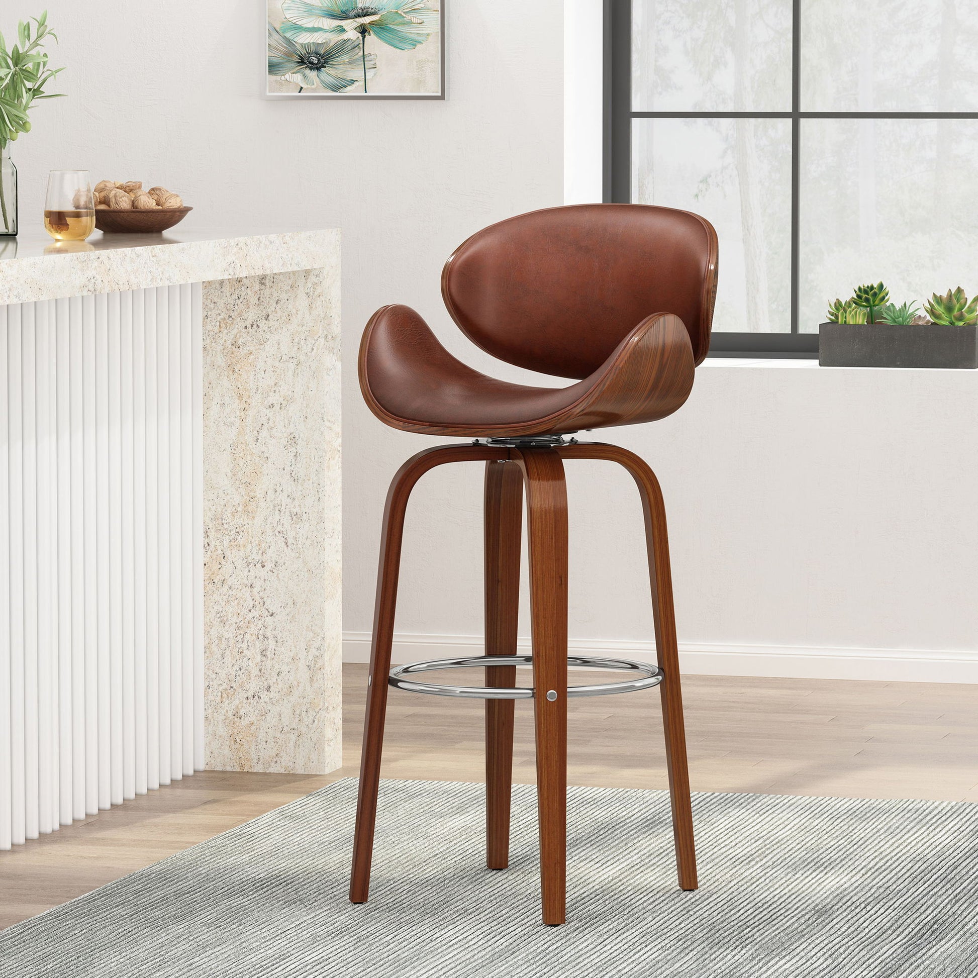 The Lumos Mid Century Modern Upholstered Swivel Barstool with a curved leather seat and backrest sits on a gray rug in a bright kitchen featuring white walls, a marble counter, wall art, and potted plants by a large window.