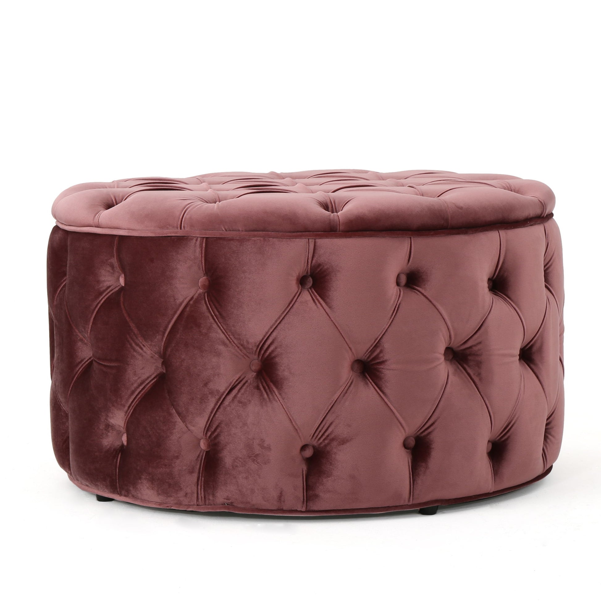 The Modern Glam Ottoman Velvet features a round, tufted design with mauve velvet upholstery, deep button accents, and a plush cushioned top.