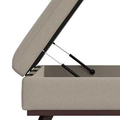 A close-up view of the Owen Multifunctional Square Coffee Table Storage Ottoman with the top lifted open, showing hydraulic lift mechanisms and interior storage space.
