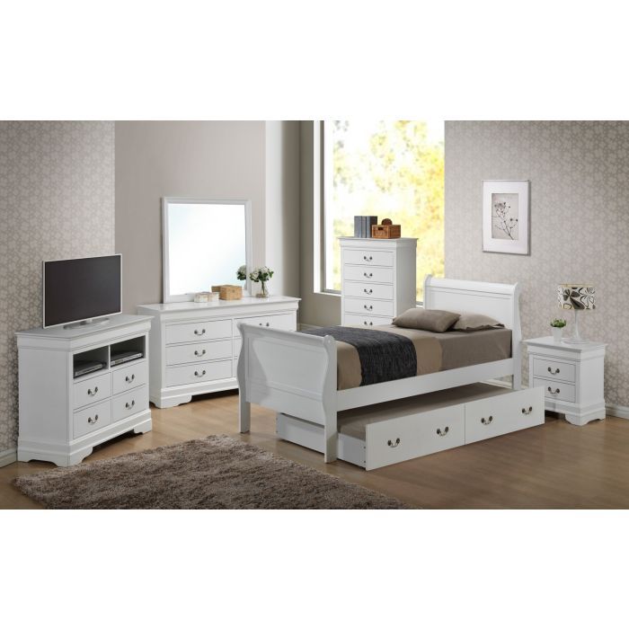 A modern bedroom features the Elegant Trundle Bed With Timeless Charm, white furniture including a nightstand, dresser with mirror, chest of drawers, TV stand, plus a large window, framed artwork, brown rug, and wooden flooring.
