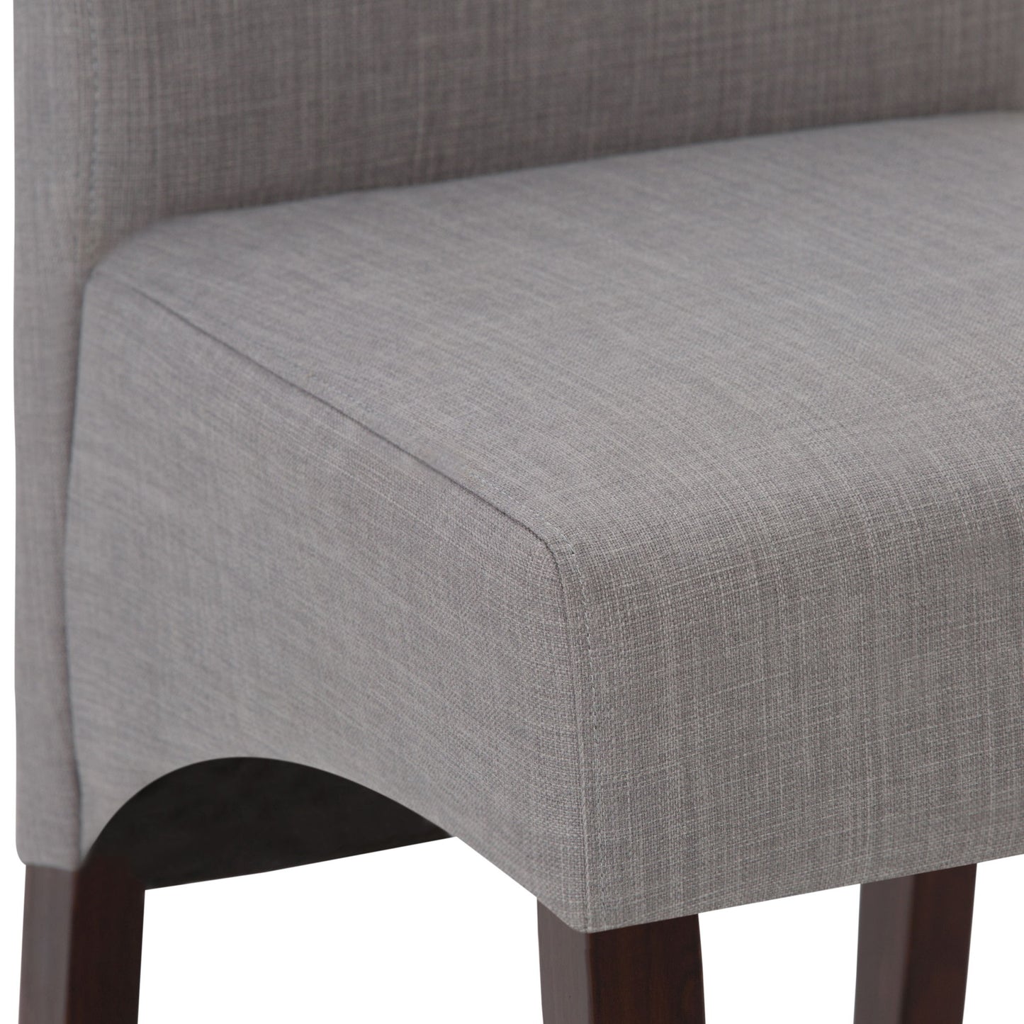 Close-up of the Avalon - Deluxe Parson Dining Chair (Set of 2), featuring light gray upholstery, dark wooden legs, and details of the seat, lower backrest, and frame.
