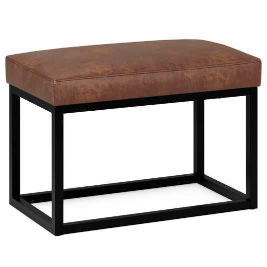 The Reynolds - Small Bench in Distressed Saddle Brown features a brown leather cushioned seat and a black metal open-frame base, displayed against a white background.