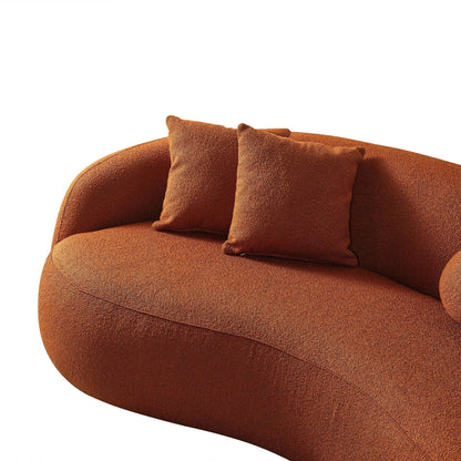 The Drake - Japandi Style Curvy Boucle Sofa is a modern curved orange piece with a textured boucle finish, featuring two matching square throw pillows, set against a plain white background.