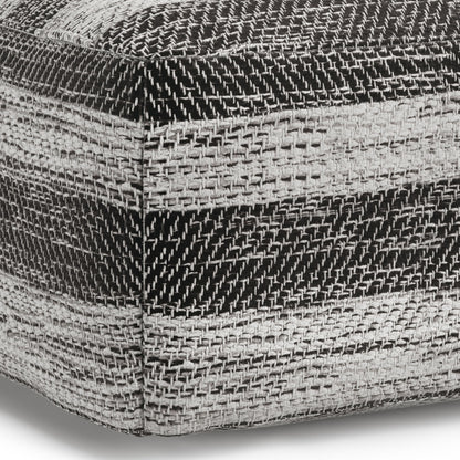 Close-up of the Clay - Square Pouf, Upholstered, showing a coarse woven fabric with horizontal black, white, and gray textured stripes and a visible corner seam.