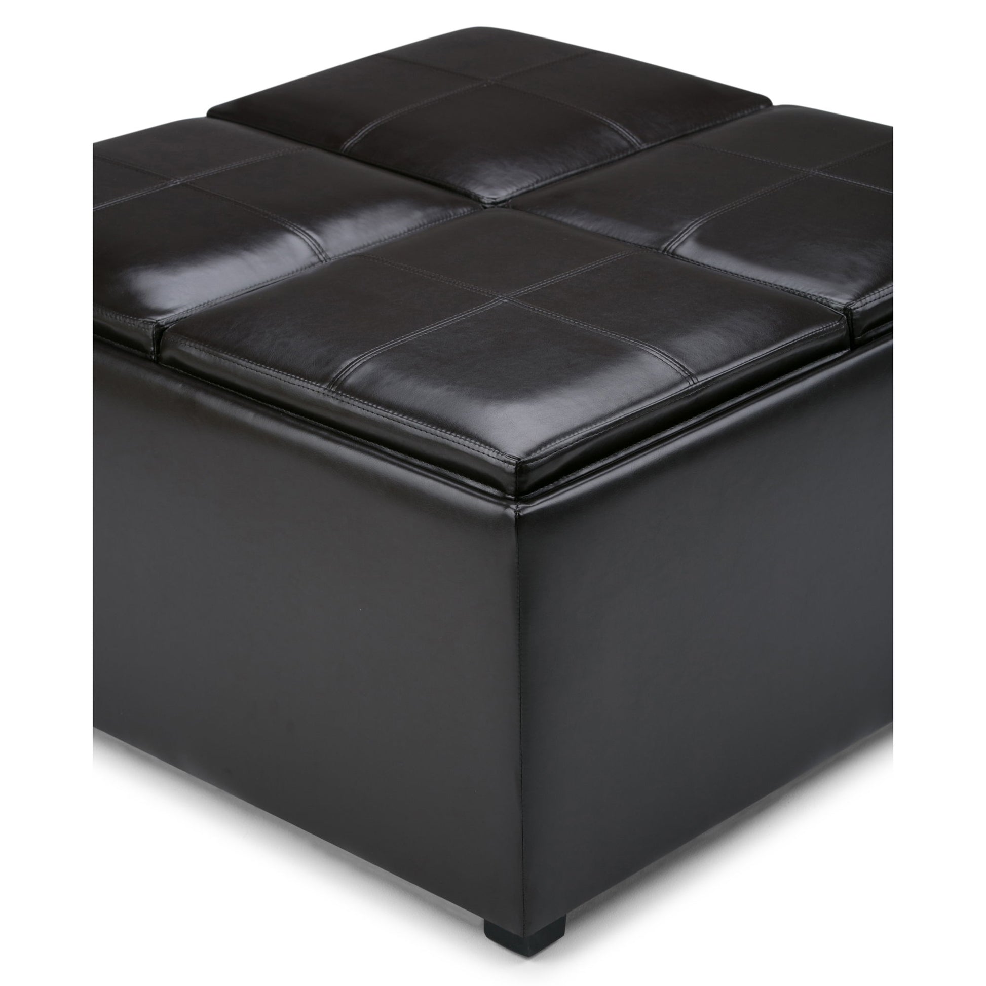 A close-up of the Avalon Square Coffee Table Storage Ottoman in Tanners Brown, featuring black leather, visible stitching, and four cushioned sections. Its simple, modern design makes it a stylish storage solution.