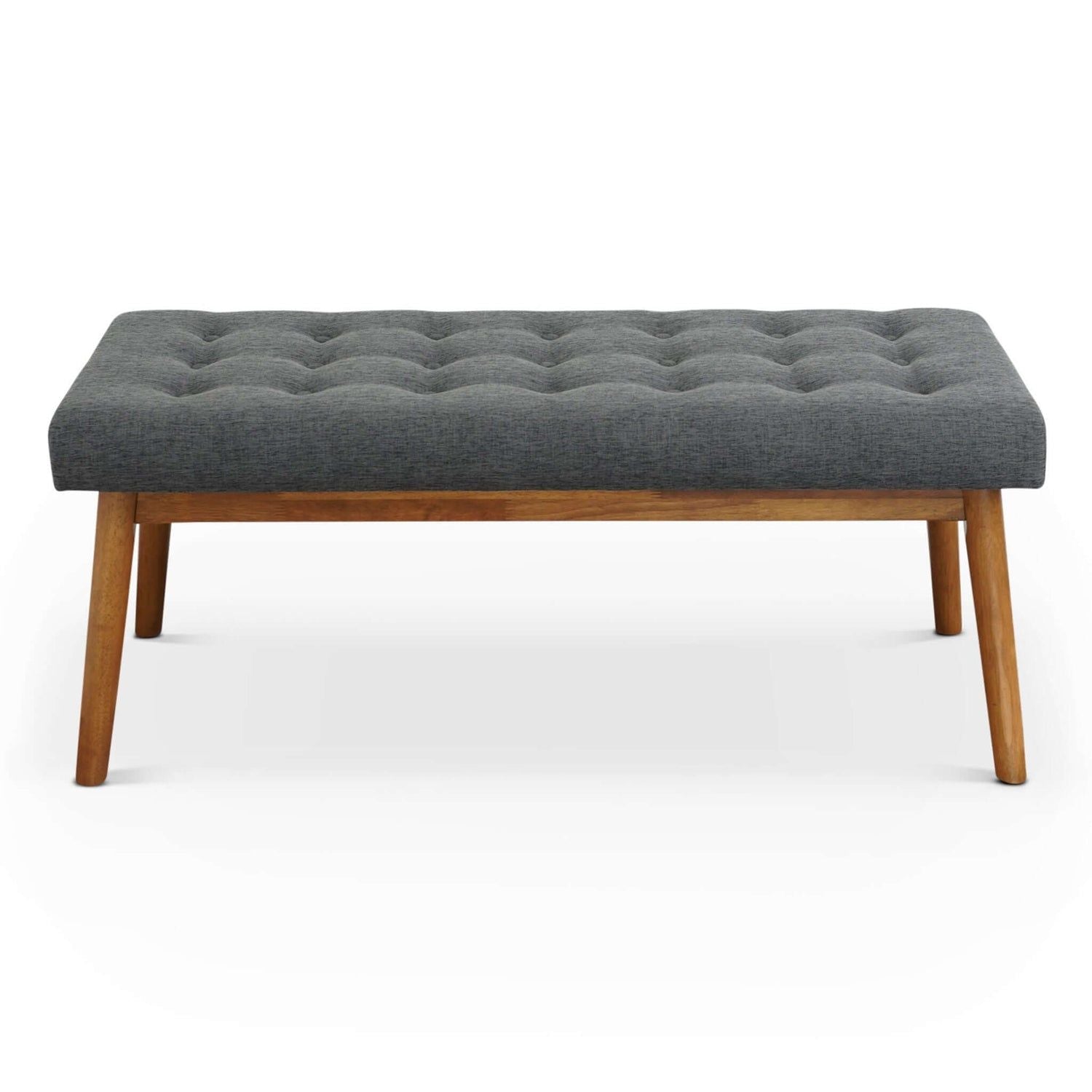 The Delilah Modern Bench features a tufted dark gray upholstered seat and four angled wooden legs, displayed against a plain white background.