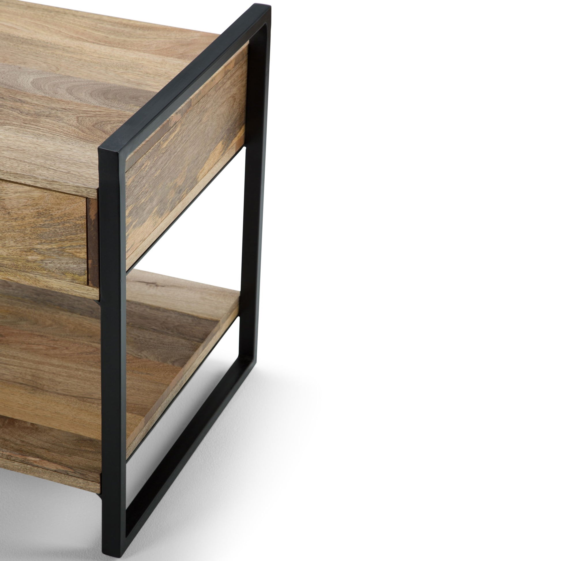 A close-up of the Riverside - Table, a modern wooden side table featuring an open black metal frame, one drawer, and a lower shelf, set against a white background.