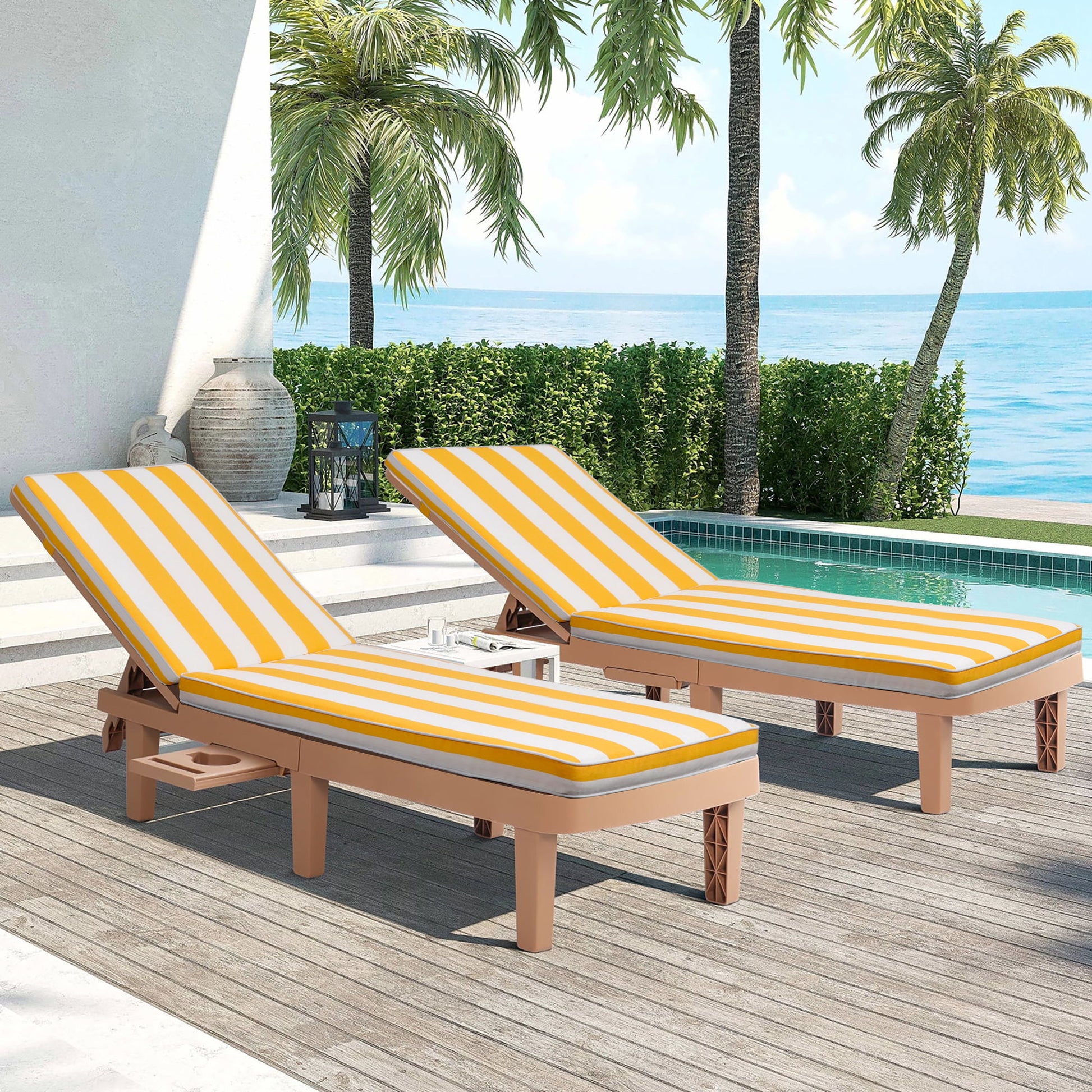 Two Outdoor Lounge Chair Cushion Replacement Patio Furniture Seat Cushions in yellow and white stripes are set on wooden loungers by a pool, with palm trees and the ocean in the background for a tropical, relaxing vibe.