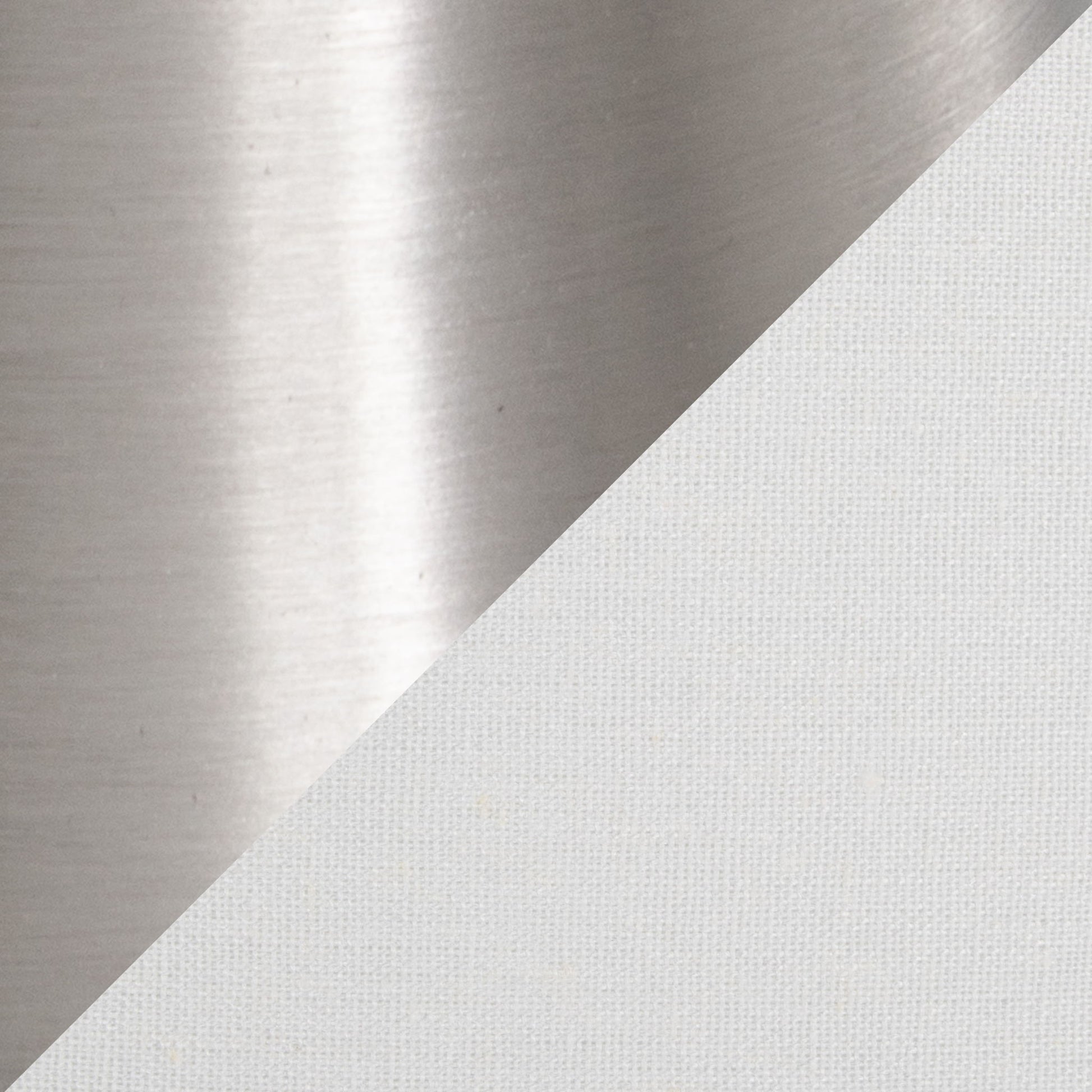 A diagonal split image showcases the Diana - Contemporary Table Lamp (Set of 2), featuring shiny brushed metal on the upper left and soft, textured white fabric on the lower right.