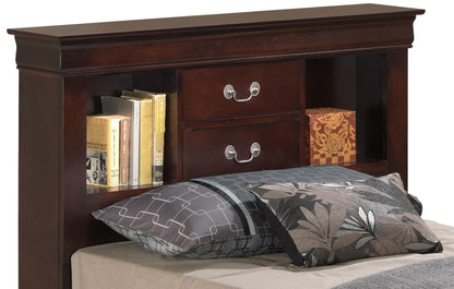 The Louis Phillipe Bookcase Storage Bed features a dark wood headboard with two silver-handled drawers and open shelves that display books and a decorative box, paired with patterned gray and black pillows and a beige sheet.