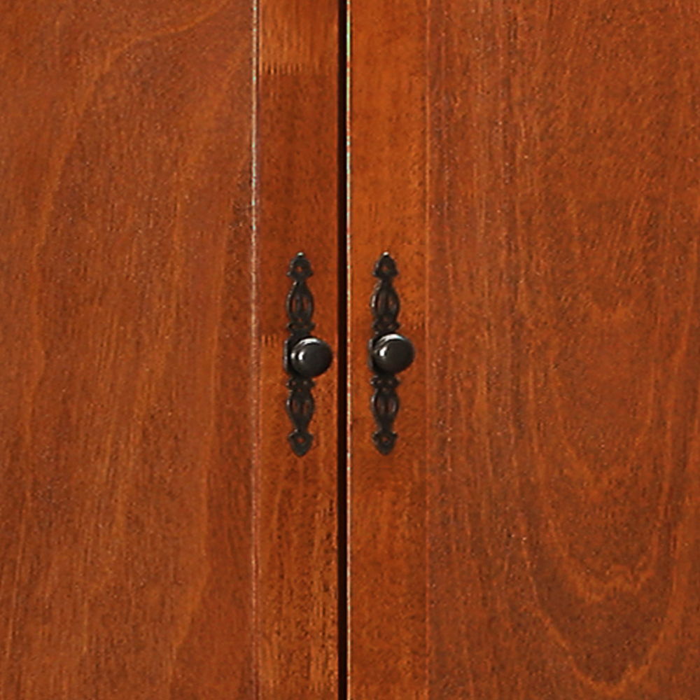 Close-up of the Elegant Traditional Armoire's two wooden doors in a rich brown finish, adorned with ornate dark metal handles and round center knobs where the doors meet.