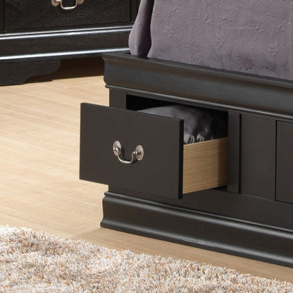 A close-up of the Louis Phillipe - Bookcase Storage Bed in black shows an open base drawer with bedding inside. The drawer features a silver handle, and a beige carpet is visible on the nearby floor.