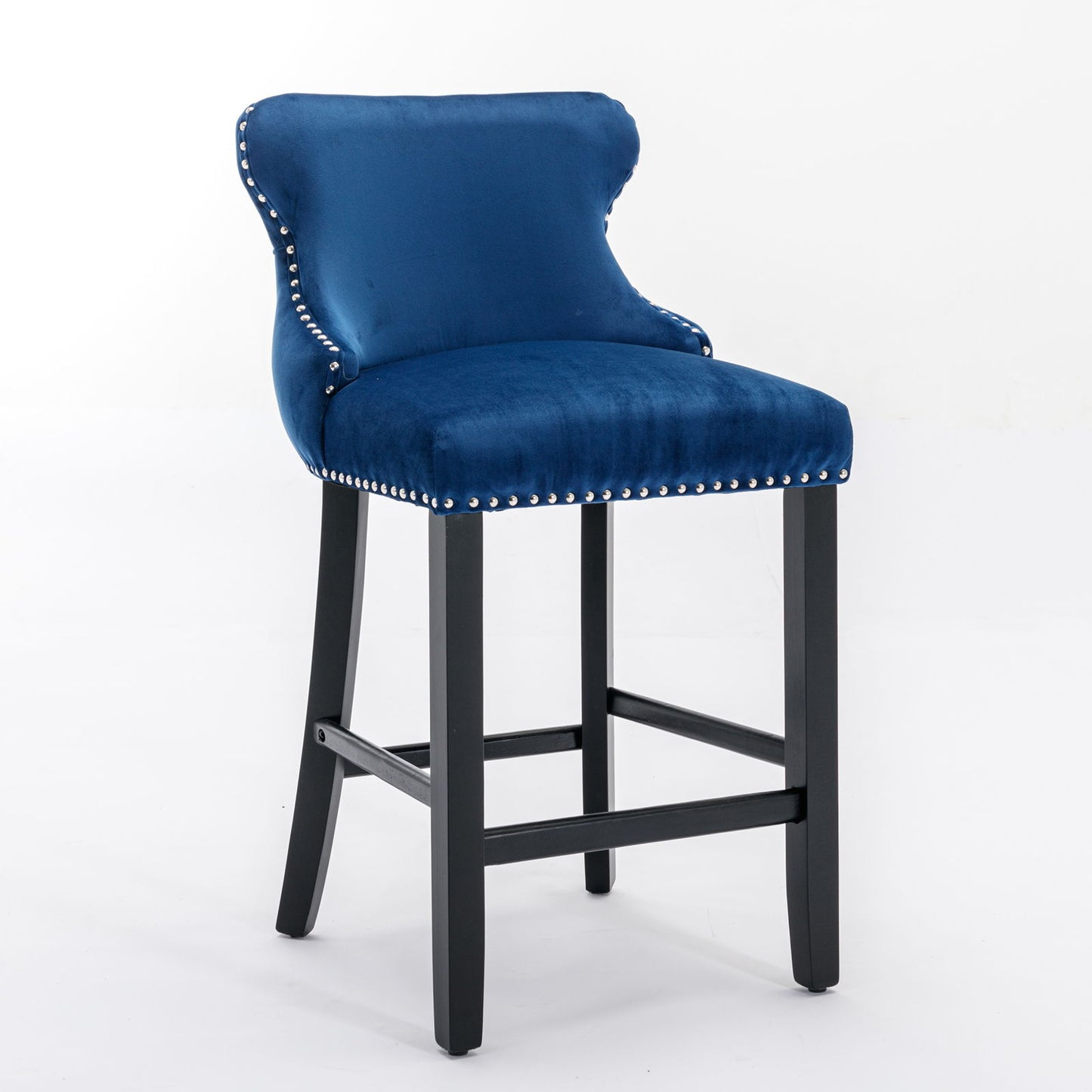 A set of 2 contemporary blue velvet wing-back bar stools with button tufted decoration, wooden legs, and chrome nailhead trim, shown on a white background.