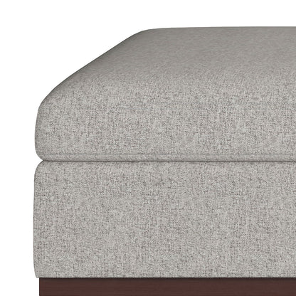 Close-up of the Owen Multifunctional Square Coffee Table Storage Ottoman, featuring a light gray textured cushion stacked on a dark wooden base, highlighting its clean lines and modern design.