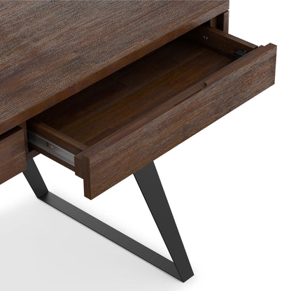 A close-up of the Lowry - Handcrafted Desk shows its textured wooden surface, open drawer, and outward-angled black metal legs.