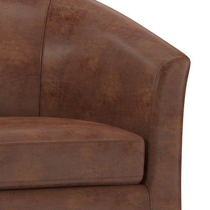 Close-up of the Austin - Handcrafted Tub Chair in brown leather, highlighting the curved backrest, armrests, and seat cushion with visible stitching and a distressed finish.