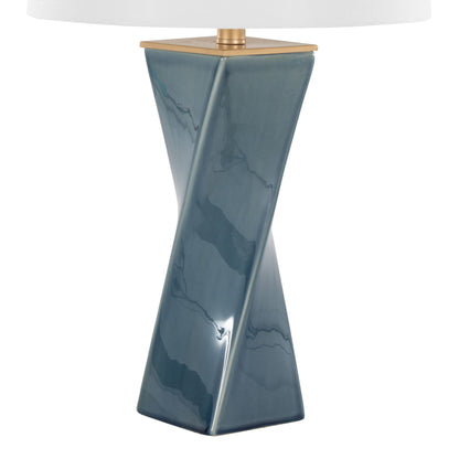 The Curvo - Square Contemporary Table Lamp features a glossy, twisted rectangular blue ceramic base with a gold accent and is topped with a white lampshade.