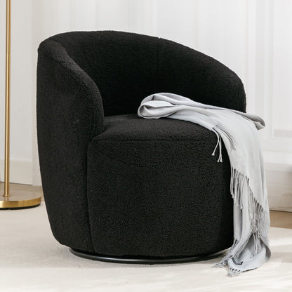 The Teddy Fabric Swivel Accent Armchair Barrel Chair with powder coated metal ring, shown in black textured fabric, is paired with a light gray fringed throw. Placed on a light rug near white curtains and a gold floor lamp.