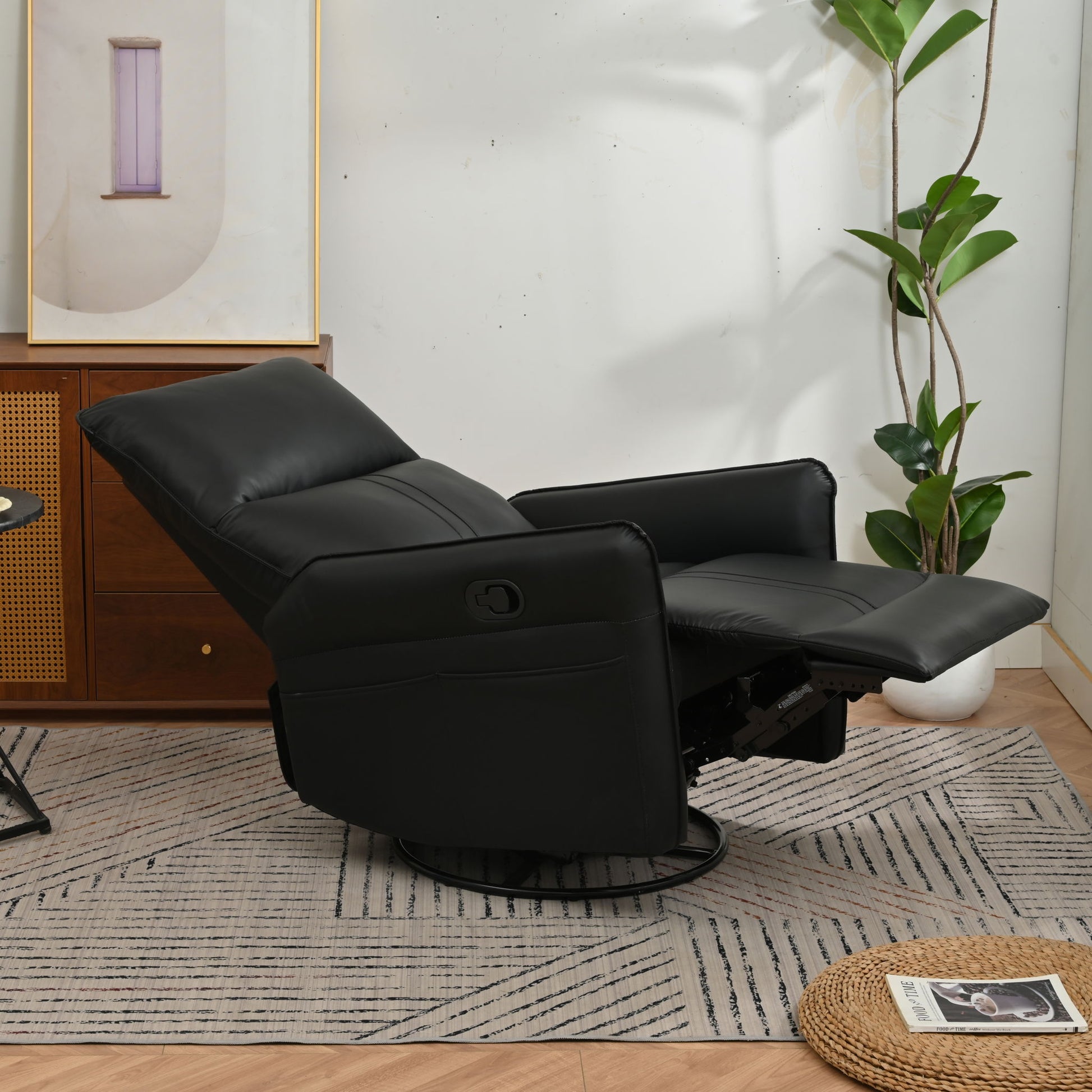 The 360° Modern Small Rocking Swivel Recliner Chair With Side Pocket is extended in a modern living room featuring a patterned rug, potted plant, wooden cabinet, abstract wall art, and a magazine on a woven mat.