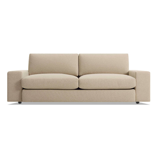 The Esker 82" Sofa in Kelso Camel is a modern beige three-seater with wide armrests and plush seat and back cushions, displayed against a plain white backdrop.