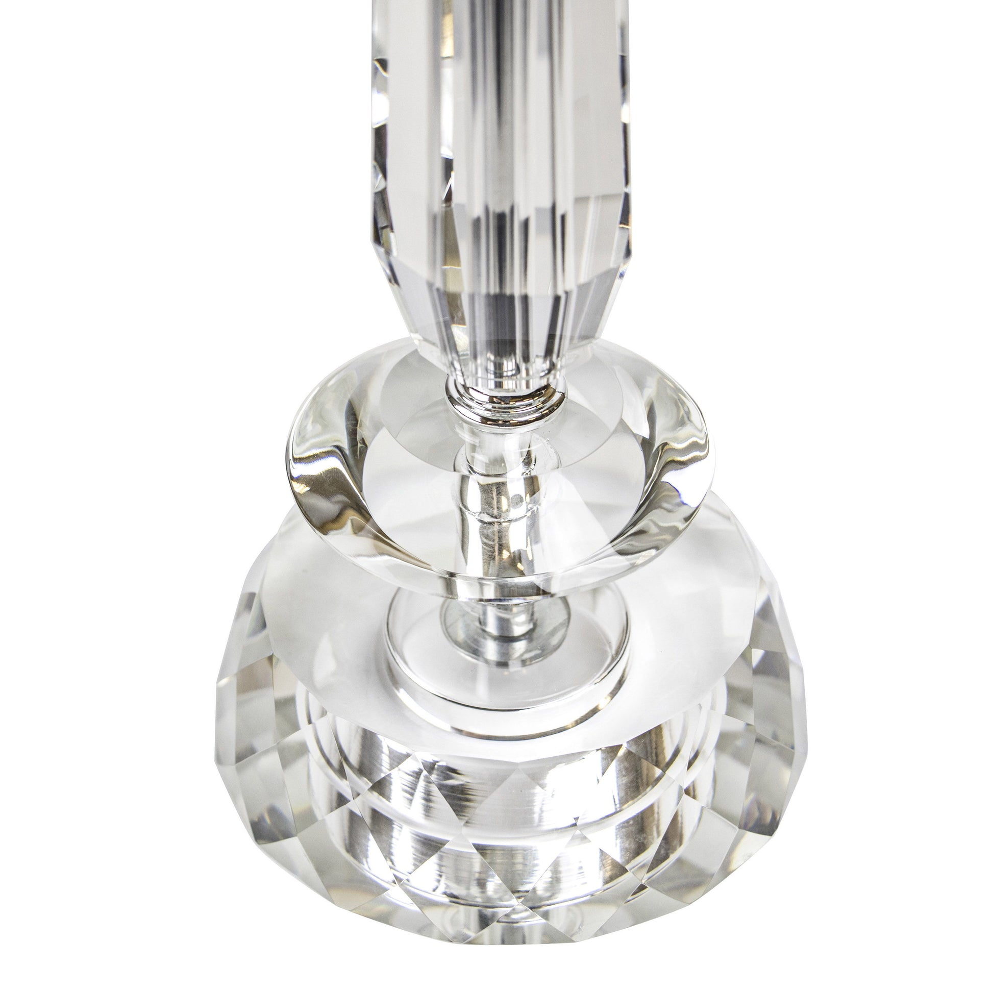 Close-up of the Karat Contemporary Crystal Table Lamp. The clear prismatic design captures and reflects light for a shimmering effect, featuring a tapered, vertically-cut column on a round base. Comes in a set of two with chrome details and white softback shades.