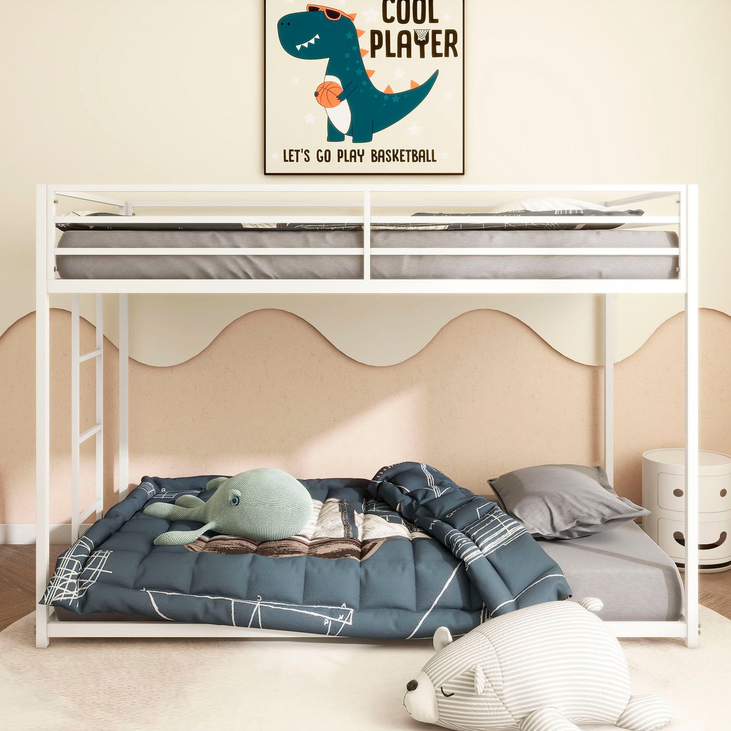 A children's bedroom with the white Adam - Metal Bunk Bed, blue bedding, a stuffed octopus toy, gray pillow, and a white bear plush on the floor. A dinosaur basketball poster above reads: "Cool Player. Let's Go Play Basketball.