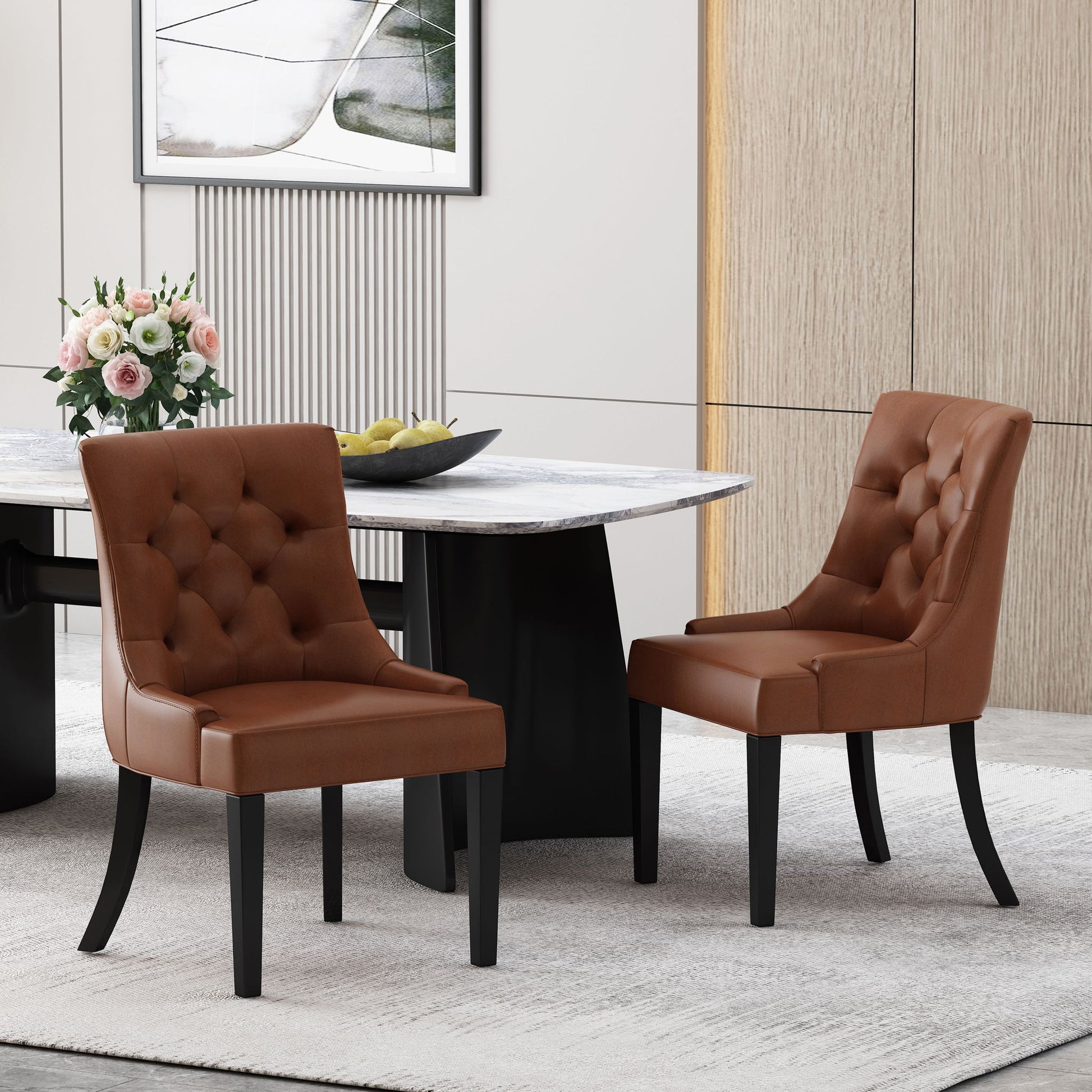 Two Cheney Contemporary Dining Chairs with tufted upholstery are placed in a modern dining room featuring a light rug, marble table, floral arrangement, and abstract wall art.