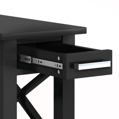 The Kitchener - Handcrafted Table features a sleek black finish, a modern rectangular silver handle, a single drawer with visible metal slides, and distinctive cross-bracing on the sides.