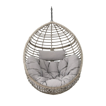 The Hanging Basket Chair With Metal Frame And Seat Cushion features an egg-shaped wicker design, grey seat cushion, headrest, and a sturdy chain suspension, all displayed against a white background.