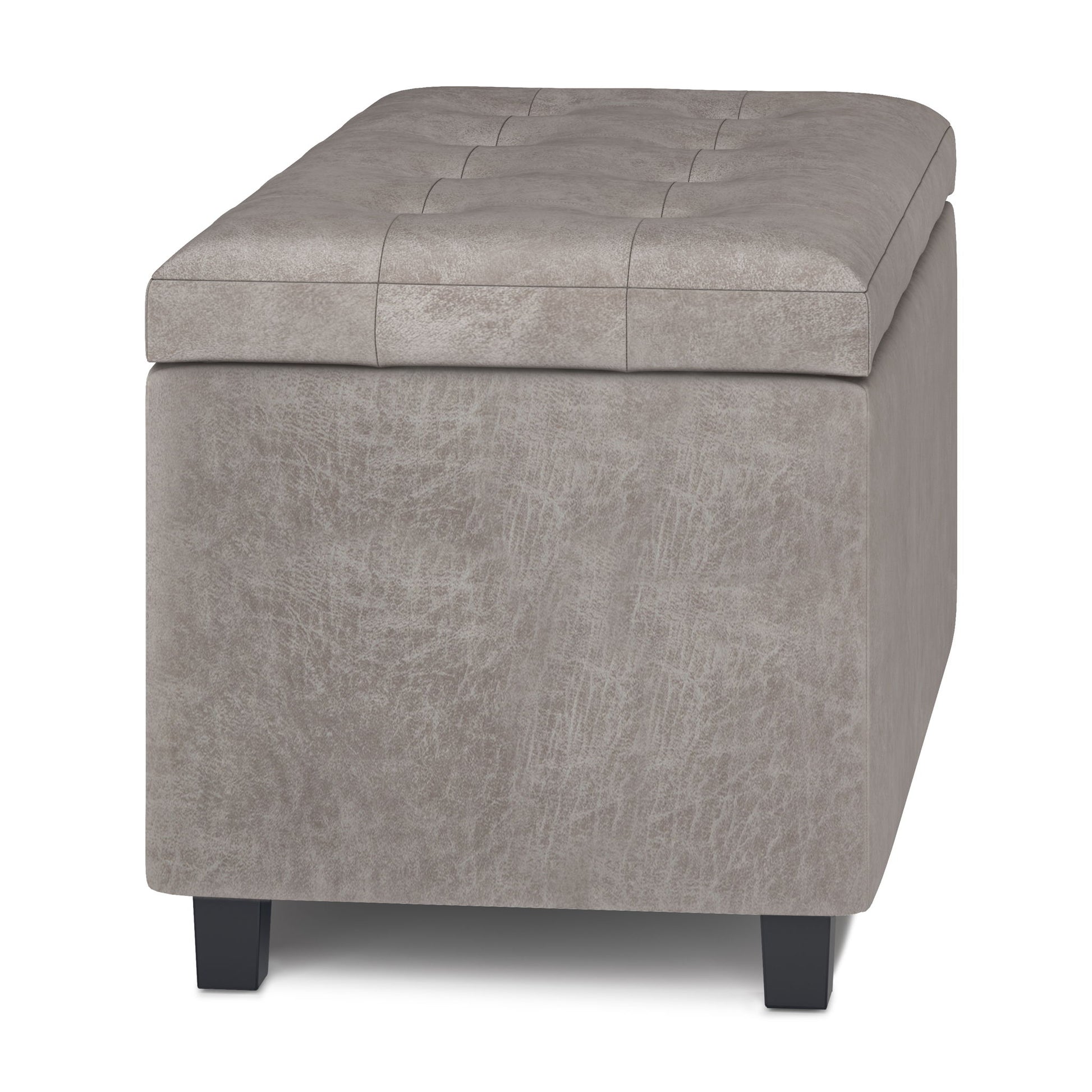 The Cosmopolitan Upholstered Storage Ottoman is rectangular, light gray, features subtle top seam detailing, and stands on black wooden legs. Shown from the front angle.