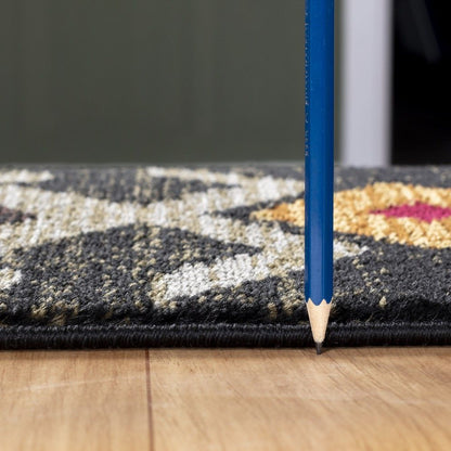 A blue pencil stands upright on a wooden floor next to the edge of the Tribes - GC_YLS4004 Southwest Area Rug, highlighting the rug’s thin thickness.