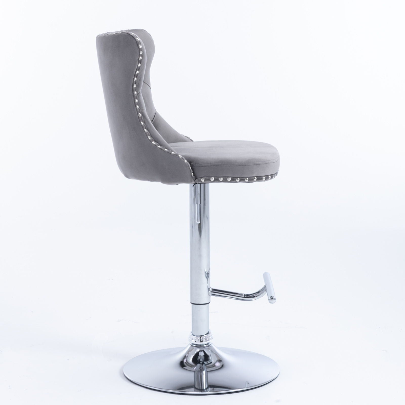 The Swivel Velvet Barstools (Set of 2) feature a modern tufted gray upholstery with cushioned back and seat, adjustable height (25-33"), chrome pedestal base, footrest, and silver stud accents, shown on a plain white background.