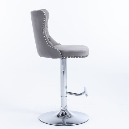 The Swivel Velvet Barstools (Set of 2) feature a modern tufted gray upholstery with cushioned back and seat, adjustable height (25-33"), chrome pedestal base, footrest, and silver stud accents, shown on a plain white background.
