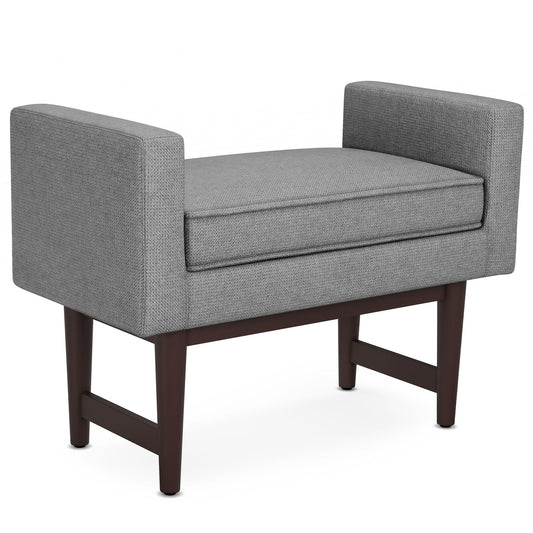 The Scott Upholstered Ottoman Bench features modern gray upholstery, rectangular arms, a cushioned seat, and dark wooden legs, shown against a white background.