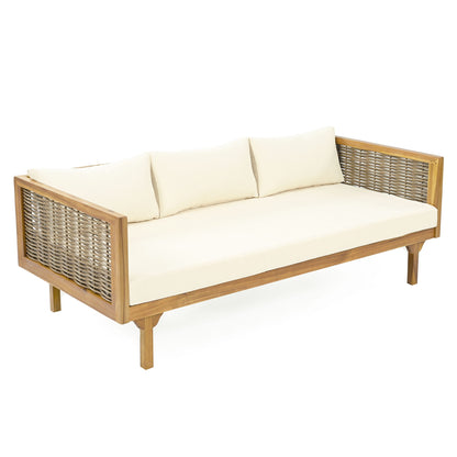 The Claremont 3 Seater Daybed features a teak acacia wood frame, woven side panels, and cream water-resistant cushions and pillows, displayed against a white background.