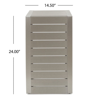 A rectangular, silver aluminum outdoor C-shaped side table for patio with horizontal slats, measuring 14.5 inches wide and 24 inches tall. Measurements are indicated by arrows next to and above the table.