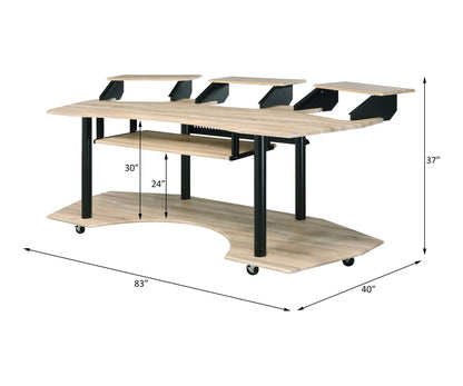 The Eleazar Music Recording Studio Desk features a spacious wood surface, black metal legs, multiple raised monitor stands, a lower shelf, and caster wheels. It measures 83"W x 40"D x 30–37"H.