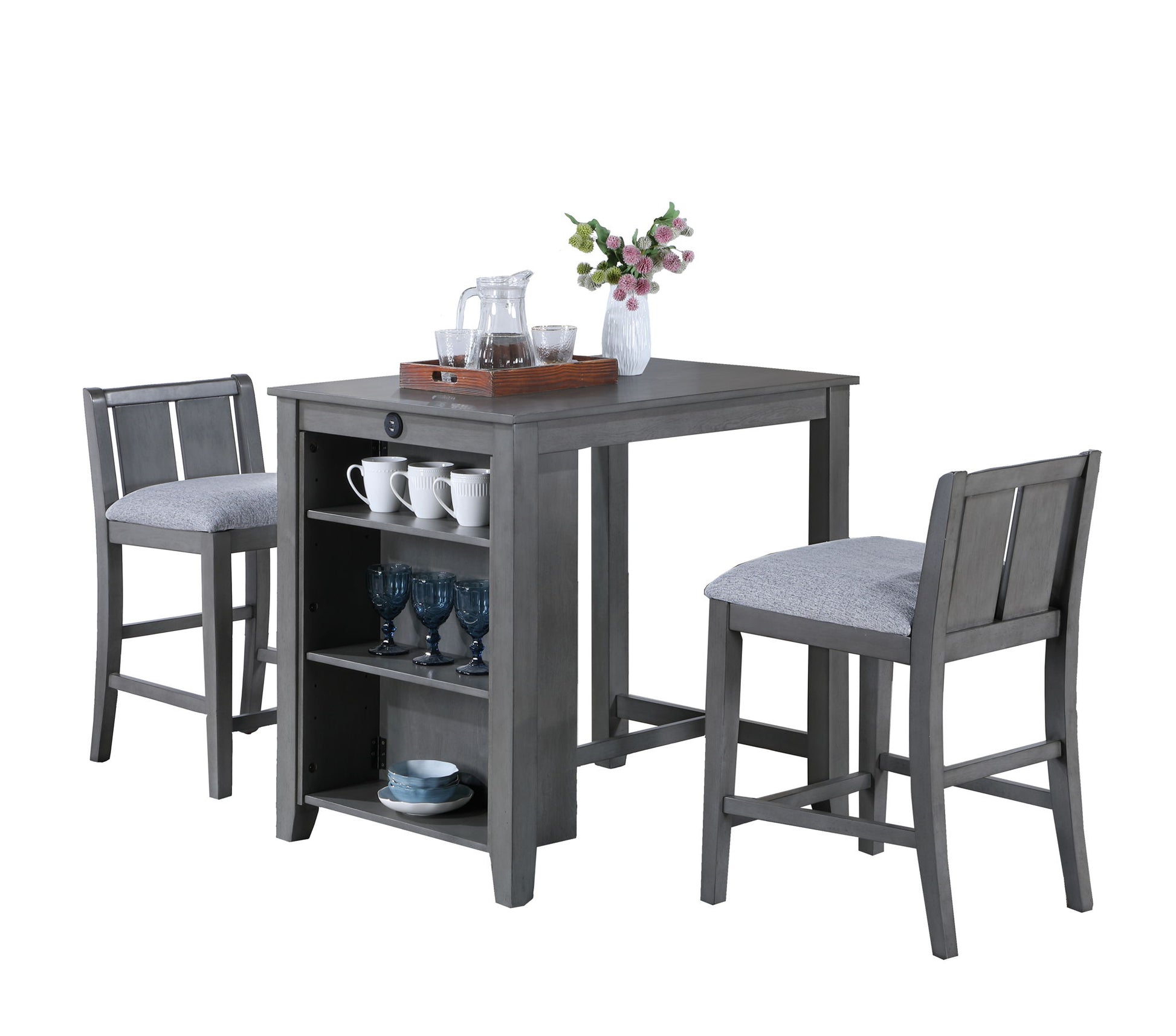 The Graham 3 Piece Small Space Counter Height Dining Table Set includes a grey wooden table with built-in shelves and two cushioned chairs. Modern and compact, it’s perfect for storing glasses and bowls in any dining area.