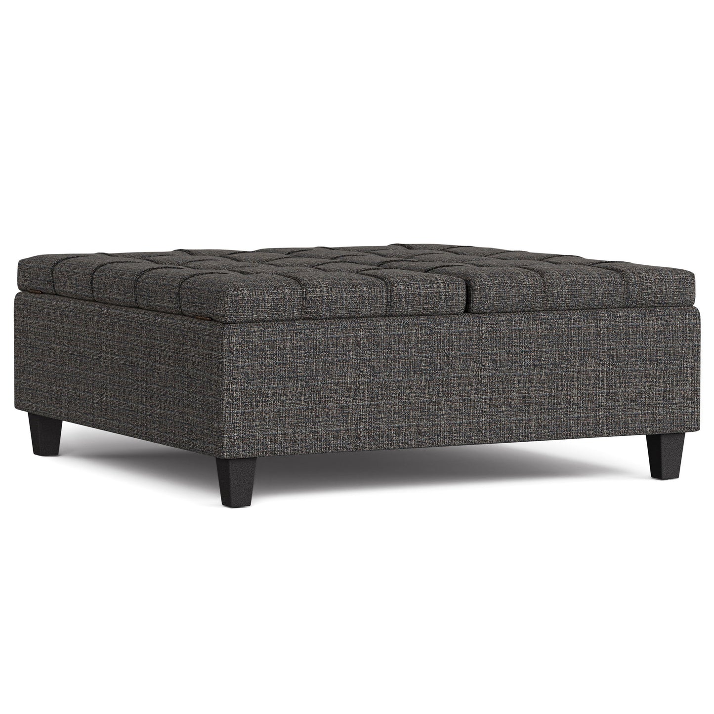 The Harrison Upholstered Coffee Table Storage Ottoman features a large square design, dark wooden legs, and a tufted top in textured dark gray fabric.