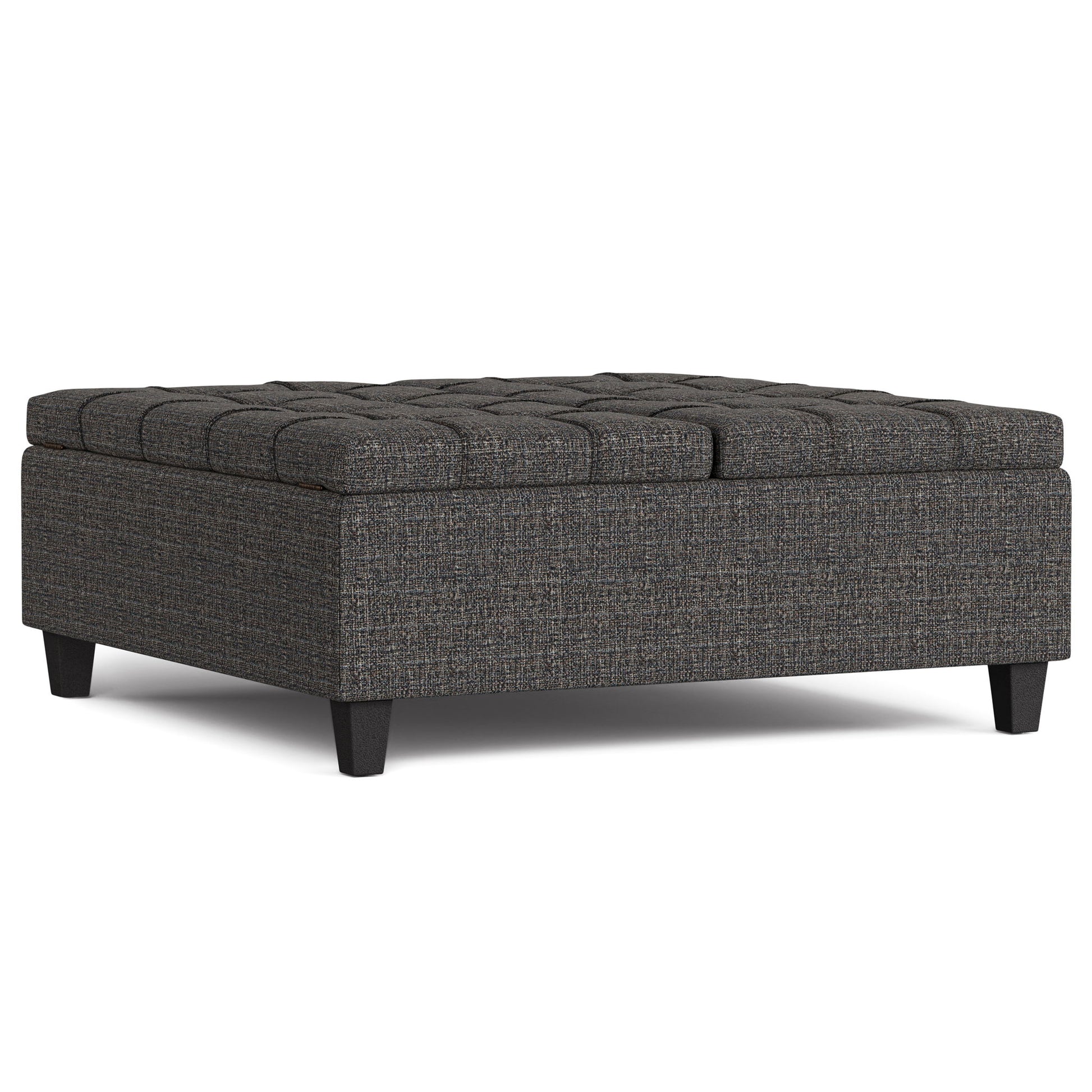 The Harrison Upholstered Coffee Table Storage Ottoman features a large square design, dark wooden legs, and a tufted top in textured dark gray fabric.