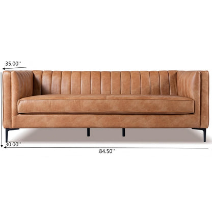 The Angelina Channel Tufted Sofa features tan leather with vertical tufting on the backrest and arms, and sturdy black legs. Dimensions are 35"H x 30"D x 84.5"W, as indicated in the labeled image.