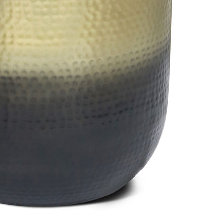 Close-up of the Nova - Handcrafted Metal Side Table, featuring a textured surface with a gradient finish that transitions from light beige at the top to dark gray at the base.