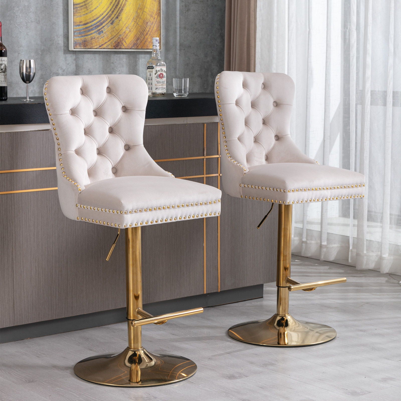 A pair of thick golden swivel velvet barstools with tufted backs and adjustable seat heights (25-33") are placed in front of a modern gray bar, creating a stylish setting for home, pub, or kitchen island.