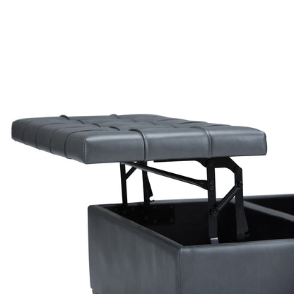 A close-up of the Harrison - Upholstered Coffee Table Storage Ottoman in black shows its tufted, padded top lifted to reveal hidden storage inside, with the lid raised on metal hinges against a white background.