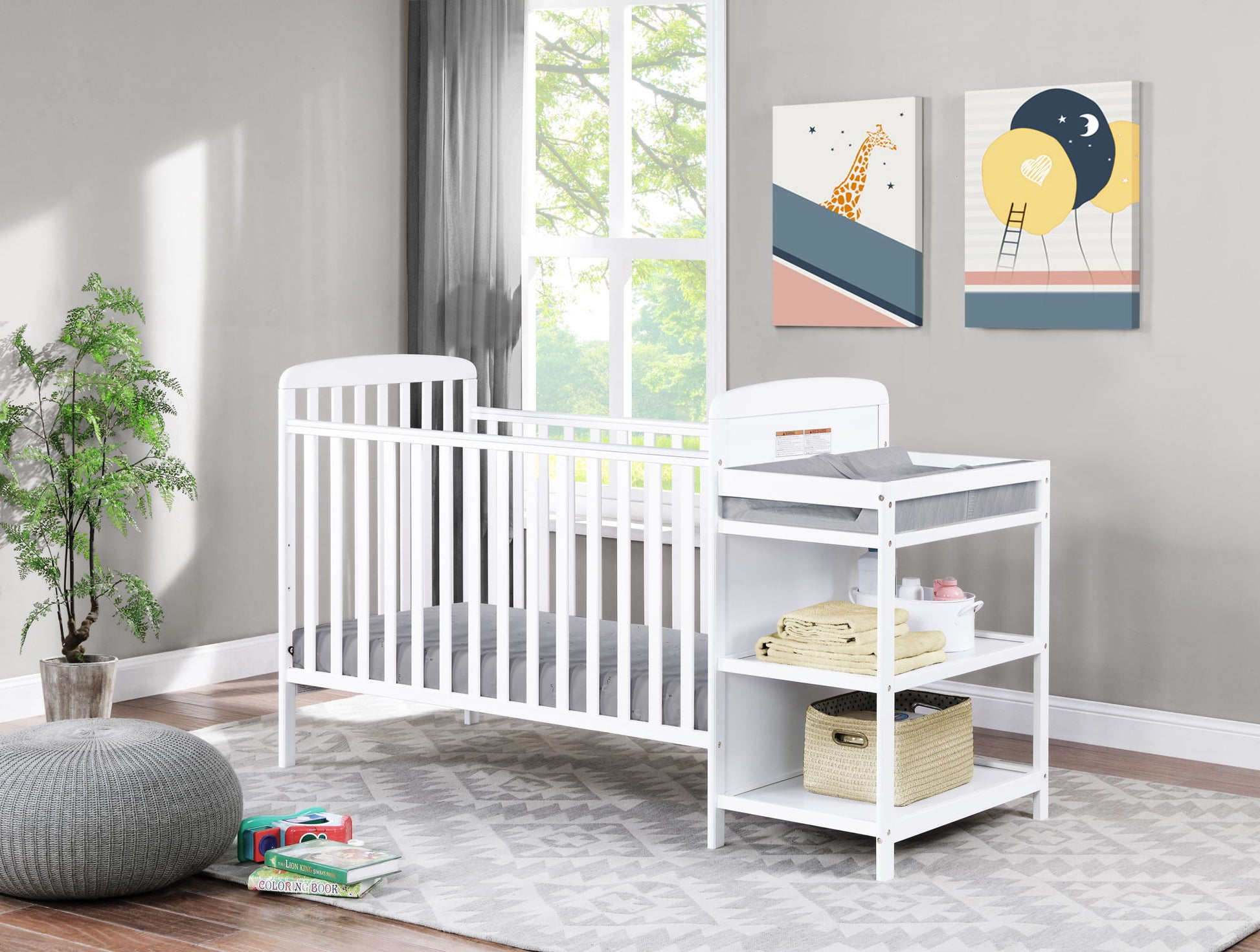 A bright nursery features the Ramsey 3-in-1 Convertible Crib / Changer Combo, a gray rug, pouf, potted plant, and two colorful animal wall art prints. Natural light streams in from a large window; baskets sit on shelves under the changer.