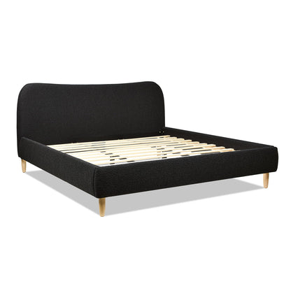 The Roman - Curved Headboard Upholstered Platform Bed features a modern design with a curved black upholstered headboard and side rails, wooden slats for support, and light wood legs, pictured on a white background.